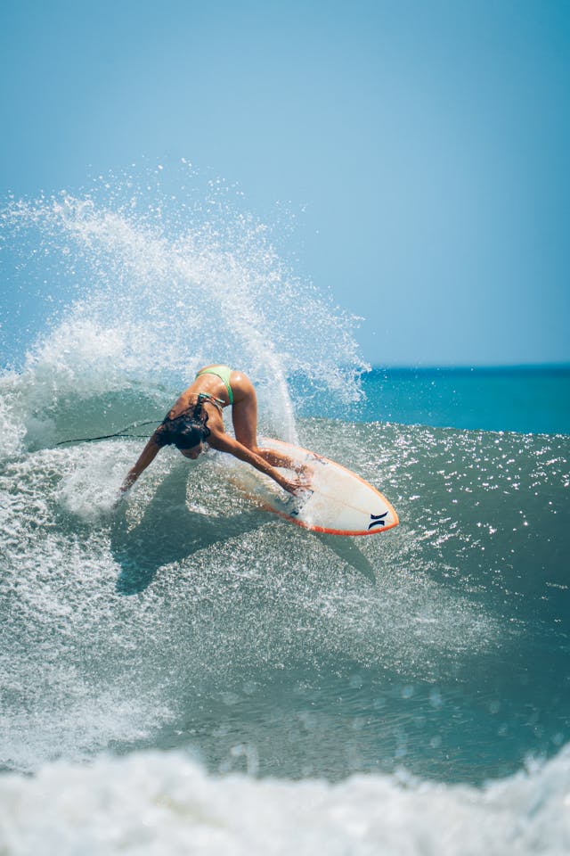 Surfer catching wave